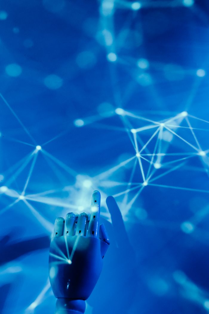 stats-img Futuristic robotic hand touching a digital network on a blue background.