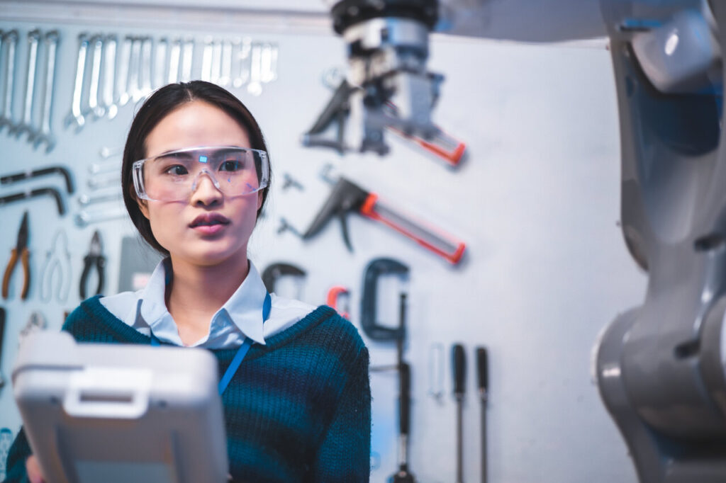 Female Engineers Maintenance Robot Arm at Lab. She are in a High